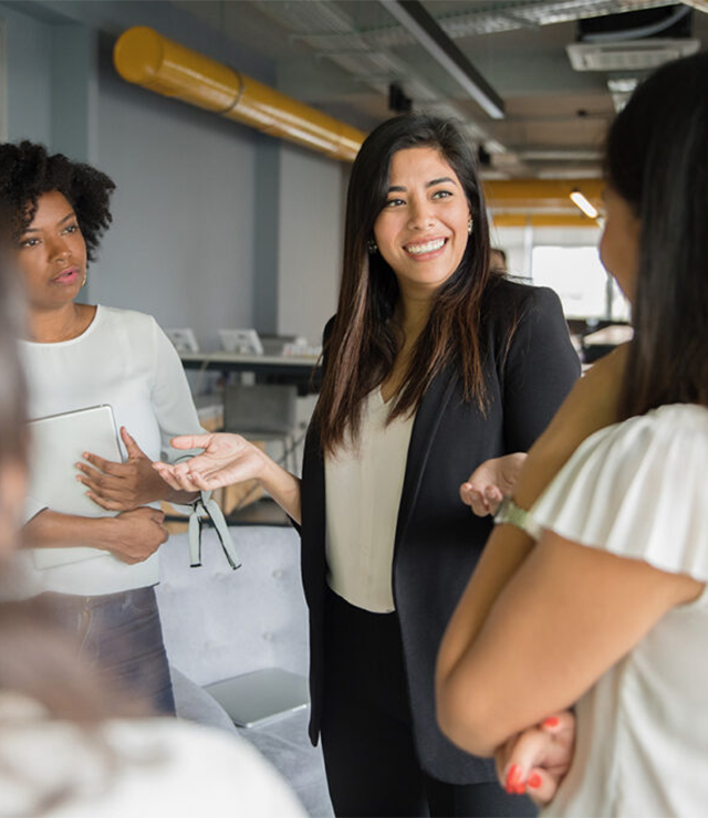 A woman talks with other women.