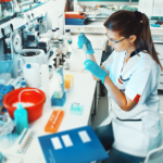 A woman conducts research in a science lab.