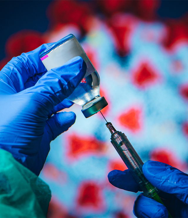 A shot of a syringe and dose of COVID vaccine.
