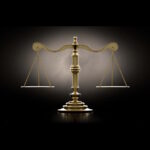 A dramtically lit gold justice scale backlit an a dark background - 3D render