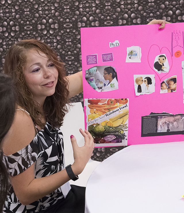 A student presents her research and poster.