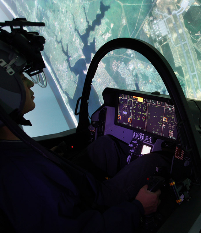 A shot of a pilot in a cockpit hovering above planet Earth.
