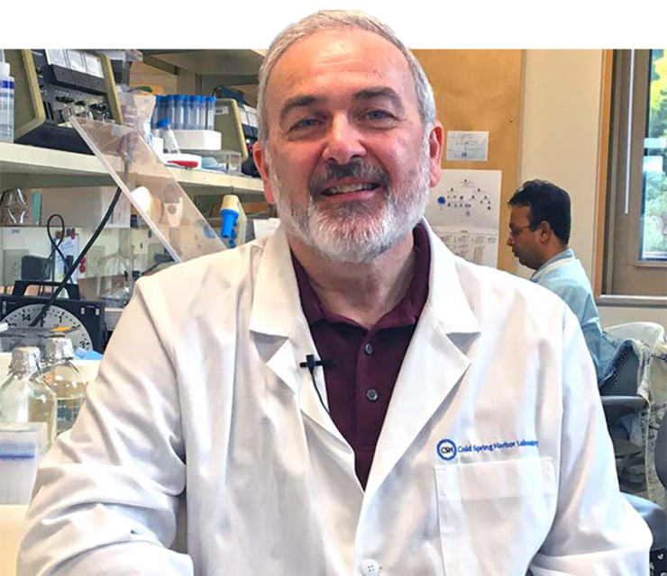 Dr. Adrian Krainer smiles for the camera inside his research lab.