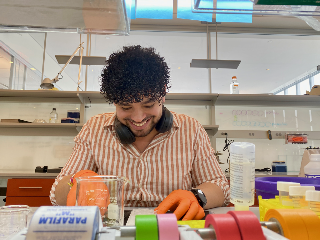 Thiago Arzua smiles while working in a lab