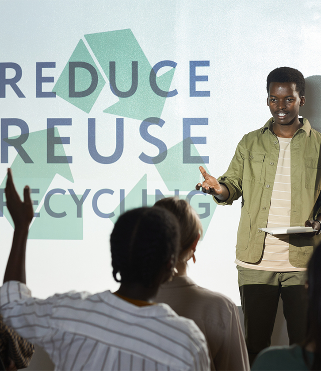 A conference attendee raises their hand to ask the presenter a question.