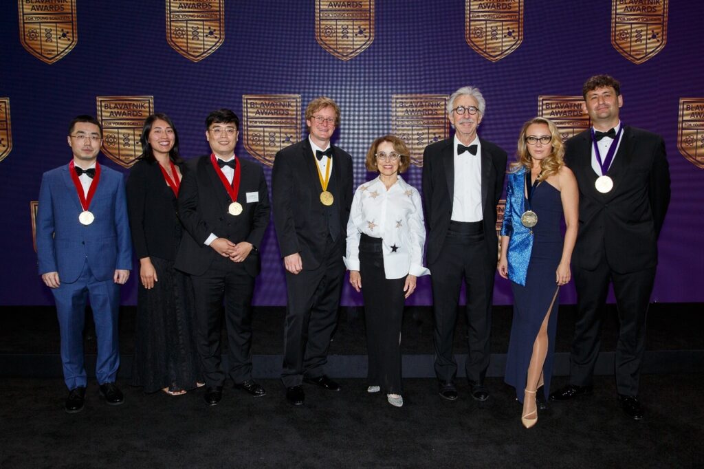 A group of award winners pose for the camera.