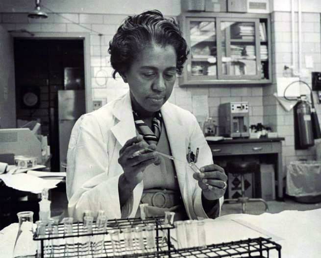 A woman works inside a science lab.
