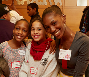 A mentor poses with her two students.