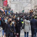 People wearing face masks on a crowded city street.