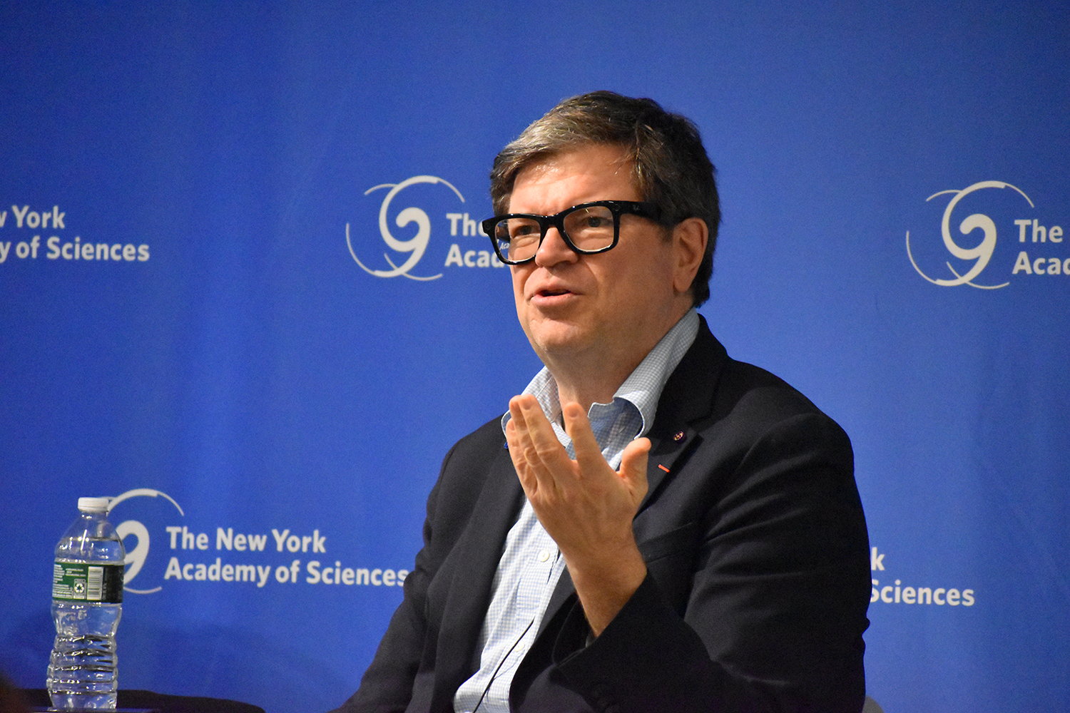 A man presents to a full house during an Academy event.