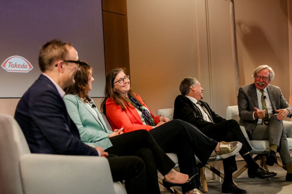 Panel members smile and laugh during a lighthearted moment at the 2024 Innovators in Science Award symposium.