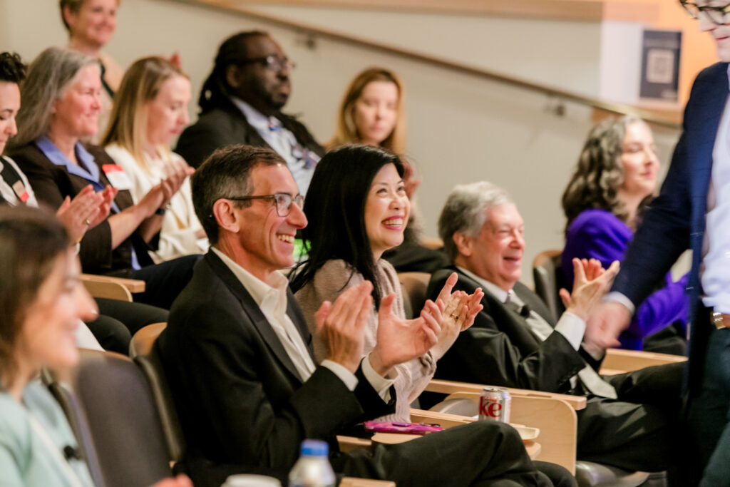 Audience members clap during the 2024 Innovators in Science Award symposium.