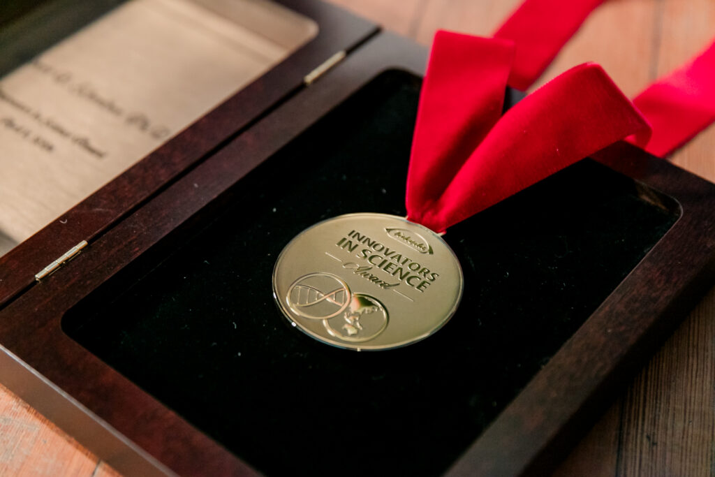 A close up shot of the 2024 Innovators in Science Award medal.
