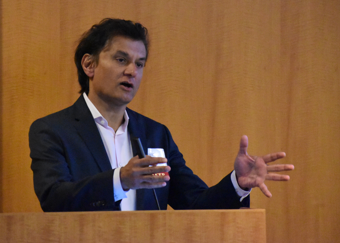 A man presents during a research symposium.