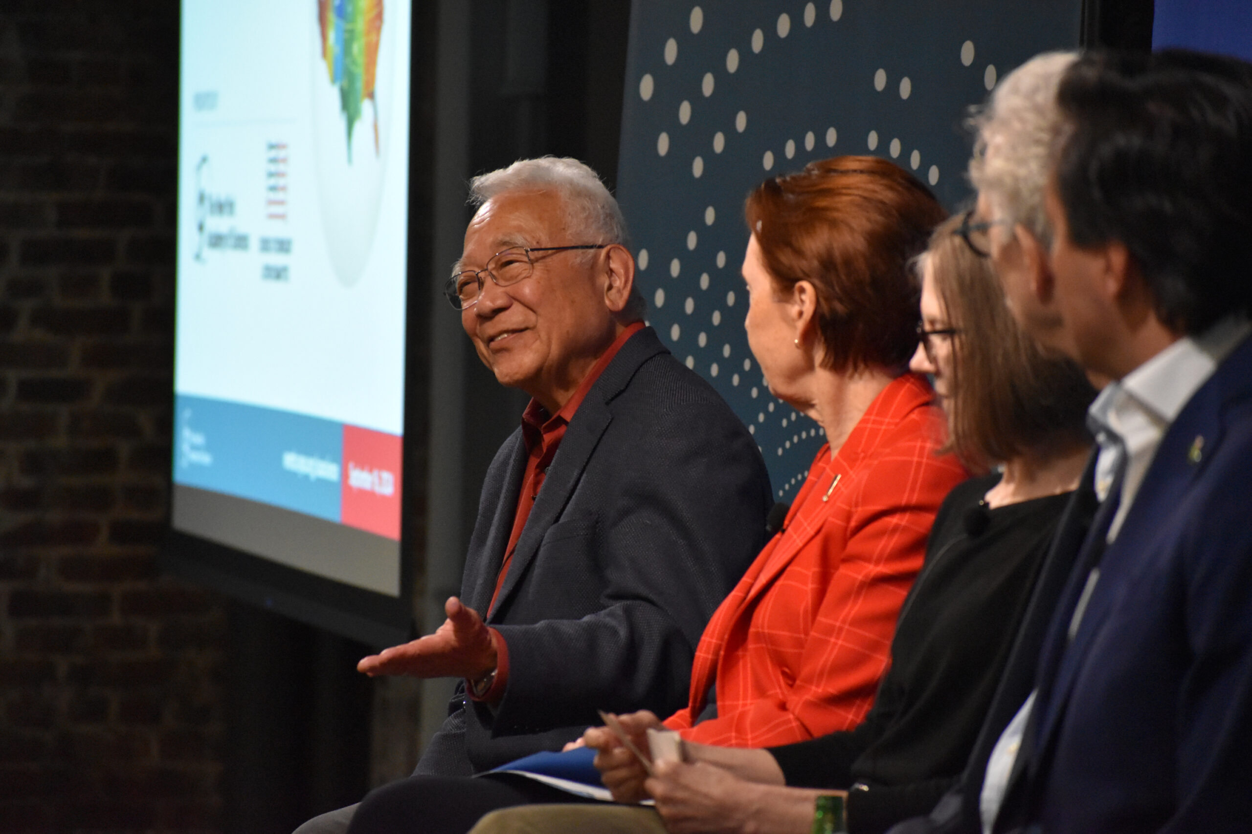A man presents during a panel event.