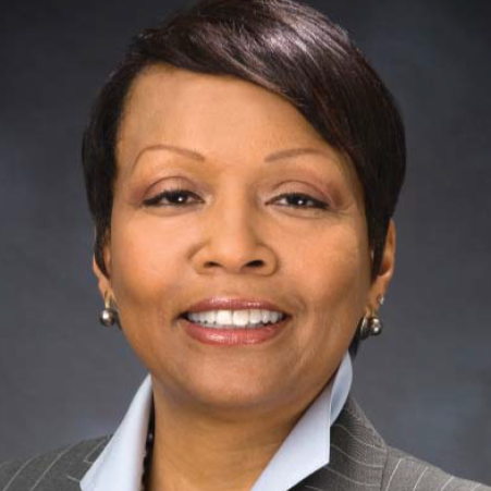 A woman smiles for the camera.