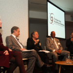 A panel discussion involving five panelists.