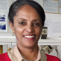 A woman smiles for the camera.