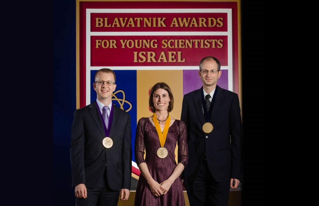 Awardees pose with the medals.