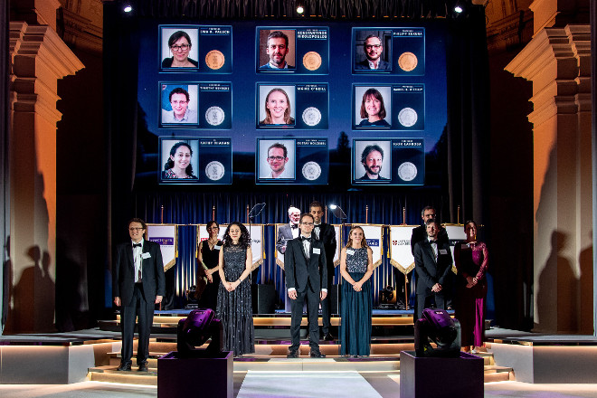 Honorees pose together on the stage.