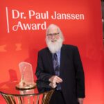 A man poses with his award.
