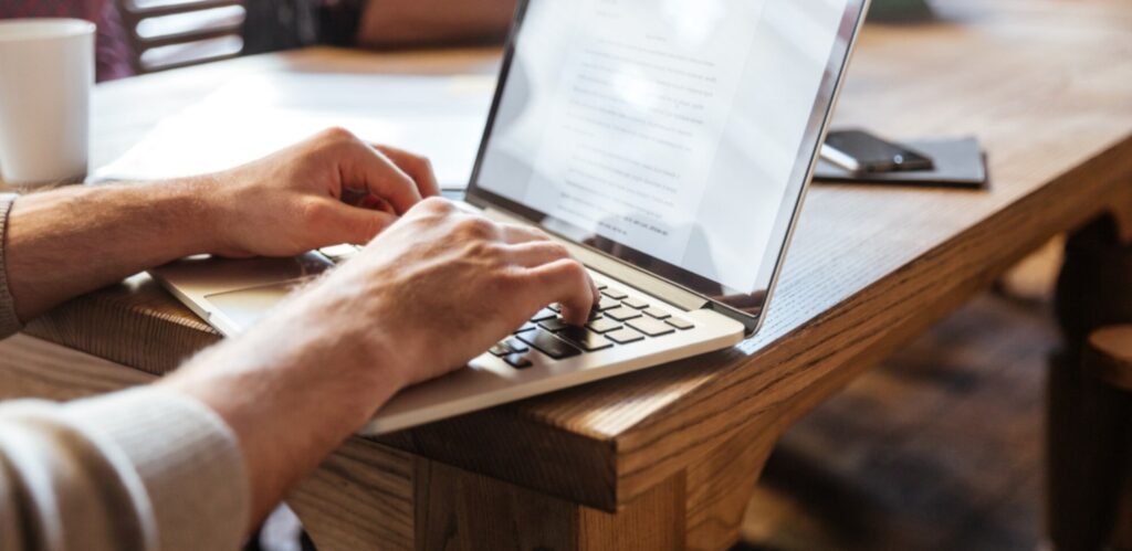 A person works on their laptop.