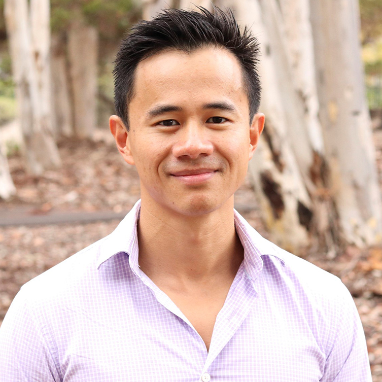 A formally dressed man smiles for the camera.