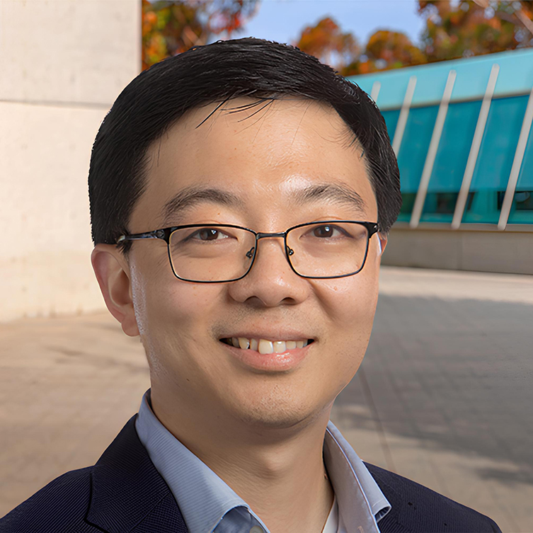 A formally dressed man smiles for the camera.
