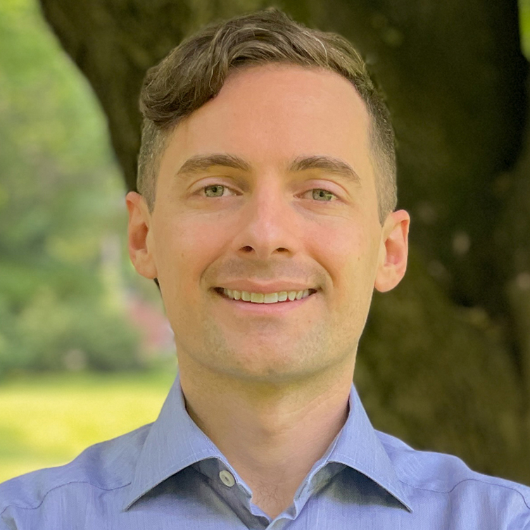 A formally dressed man smiles for the camera.