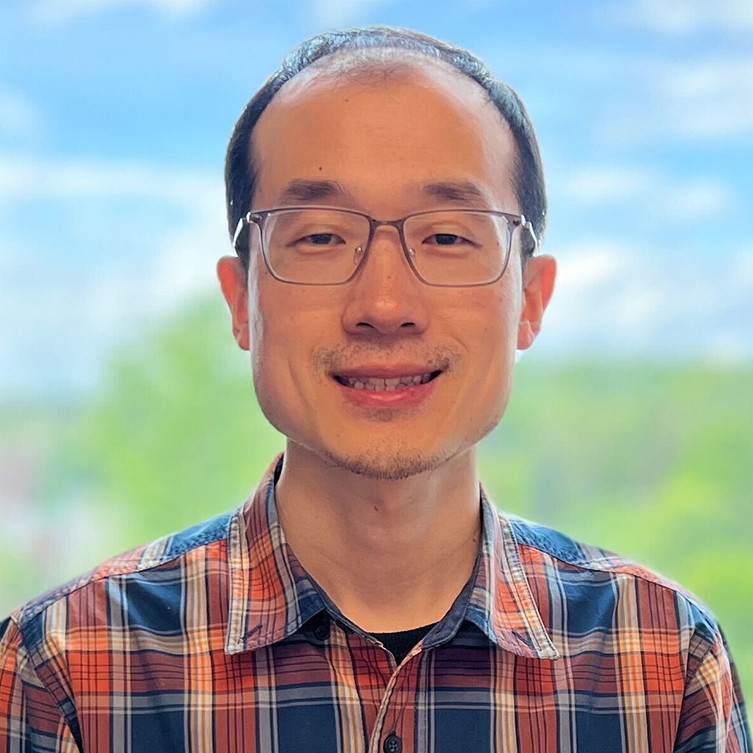 A formally dressed man smiles for the camera.
